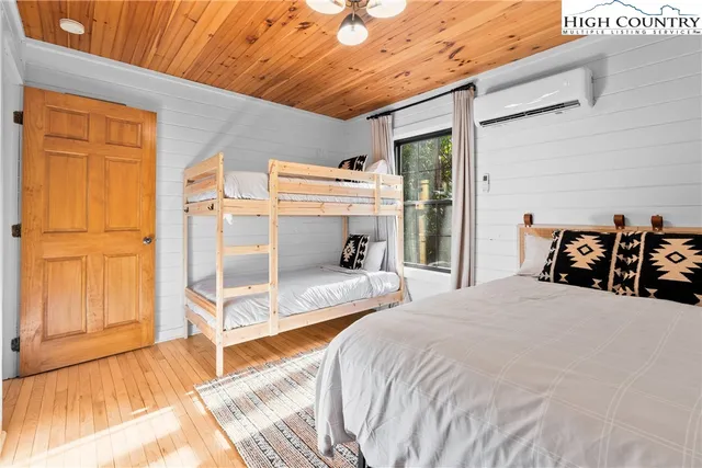 a bed sitting in a bedroom next to a window