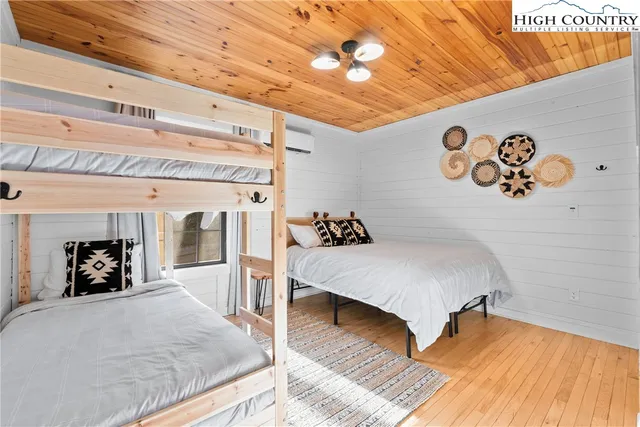 a bedroom with a bed next to a window with the outer view