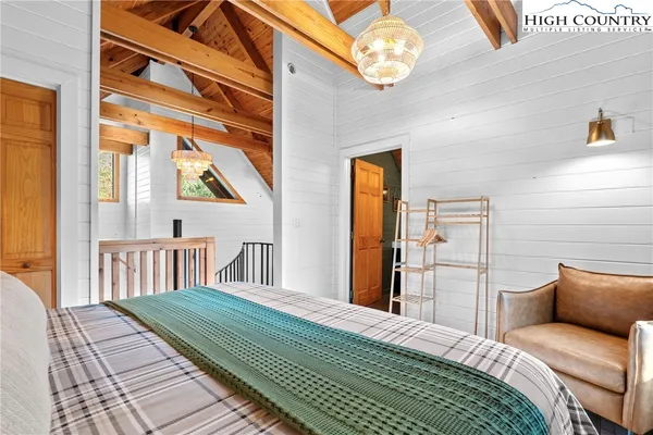 a bedroom with a bed next to a window with the outer view