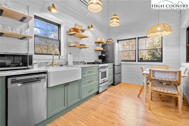 a kitchen with stainless steel appliances granite countertop a stove and a sink