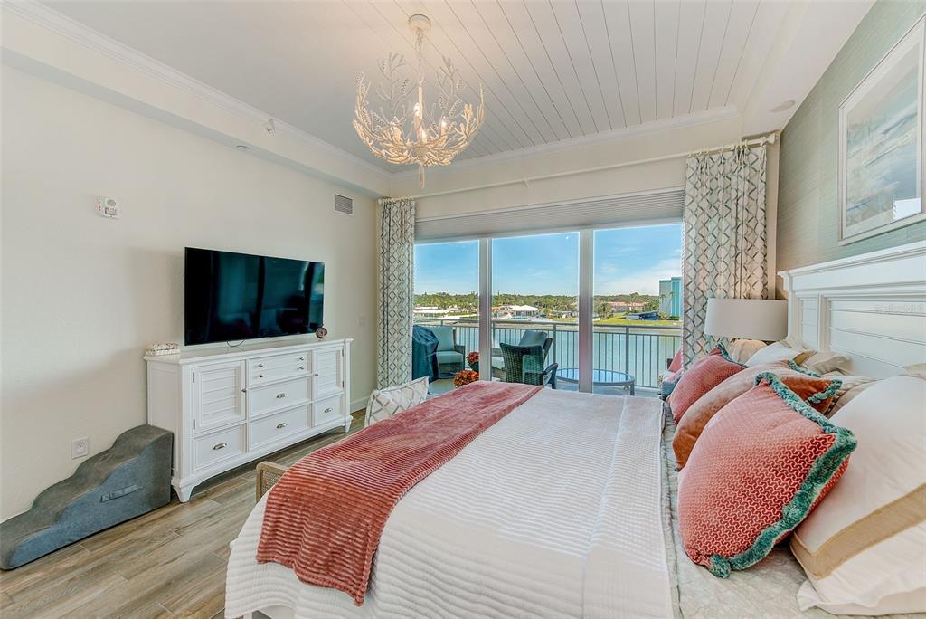 20001 Gulf Boulevard, Unit 403 Indian Shores, FL 33785 - Photo 14 of 43 a bedroom with a bed and a flat screen tv