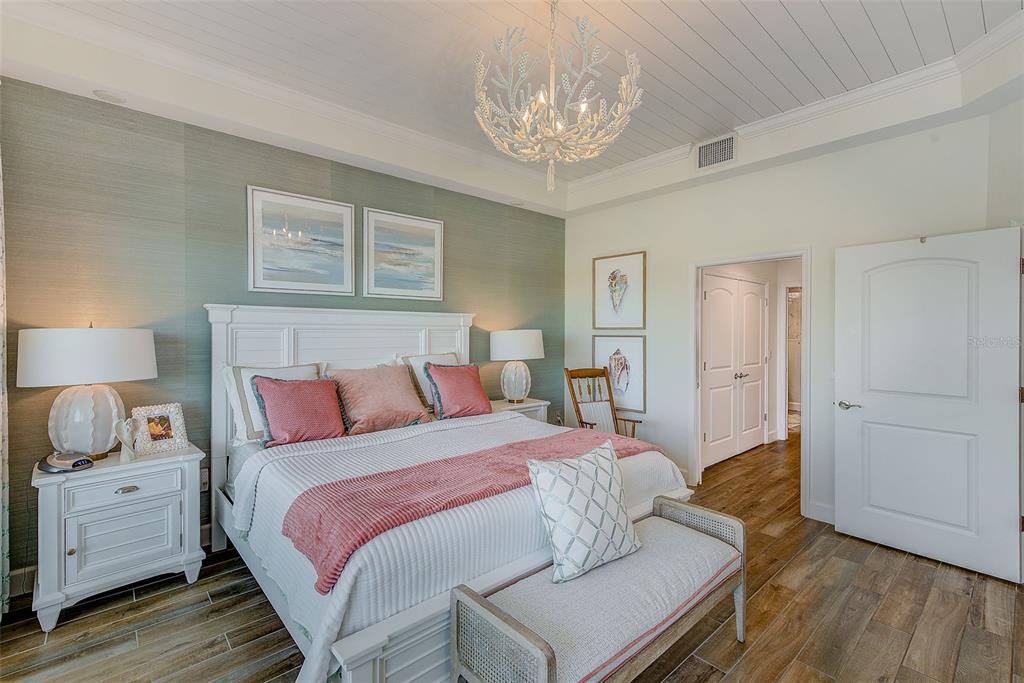 20001 Gulf Boulevard, Unit 403 Indian Shores, FL 33785 - Photo 15 of 43 a bedroom with a bed and wooden floor