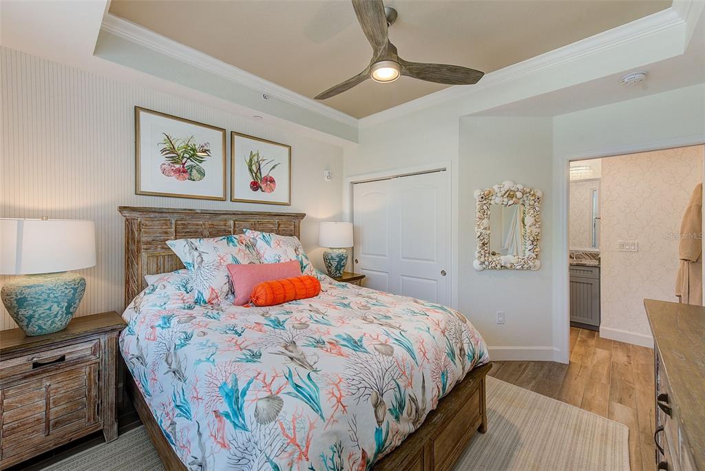 20001 Gulf Boulevard, Unit 403 Indian Shores, FL 33785 - Photo 20 of 43 a bedroom with a bed and wooden floor