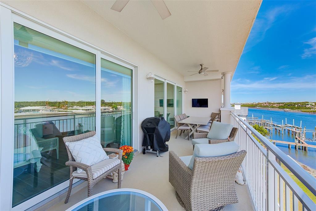 20001 Gulf Boulevard, Unit 403 Indian Shores, FL 33785 - Photo 26 of 43 a living room with furniture and a floor to ceiling window