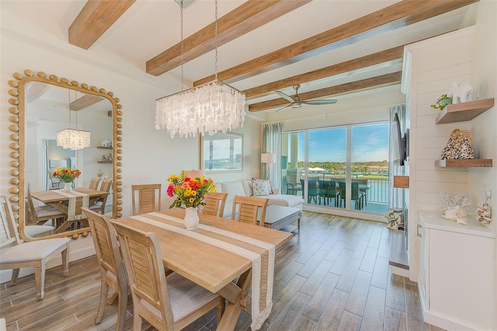 20001 Gulf Boulevard, Unit 403 Indian Shores, FL 33785 - Photo 3 of 43 a view of a dining room with furniture and wooden floor