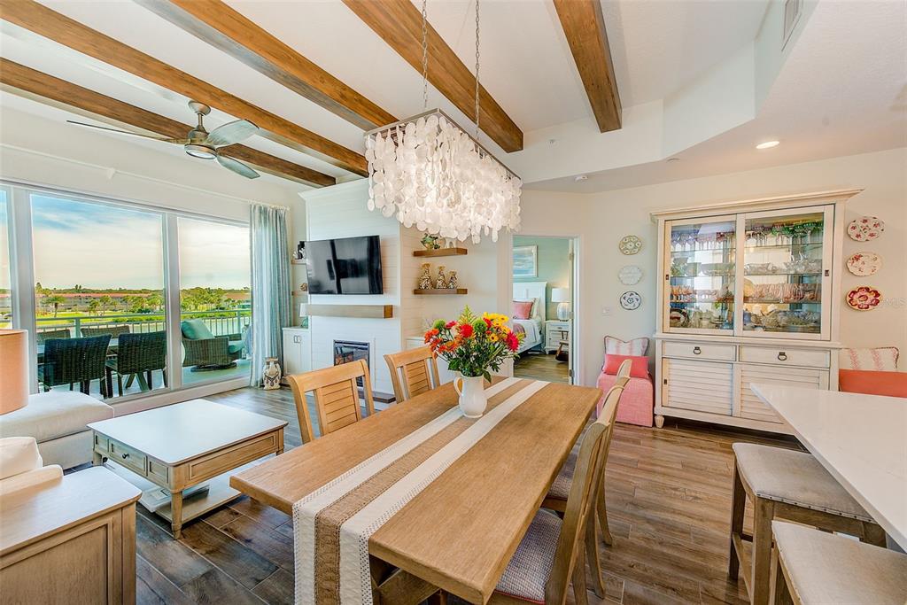 20001 Gulf Boulevard, Unit 403 Indian Shores, FL 33785 - Photo 4 of 43 a view of a dining room with furniture large windows and wooden floor