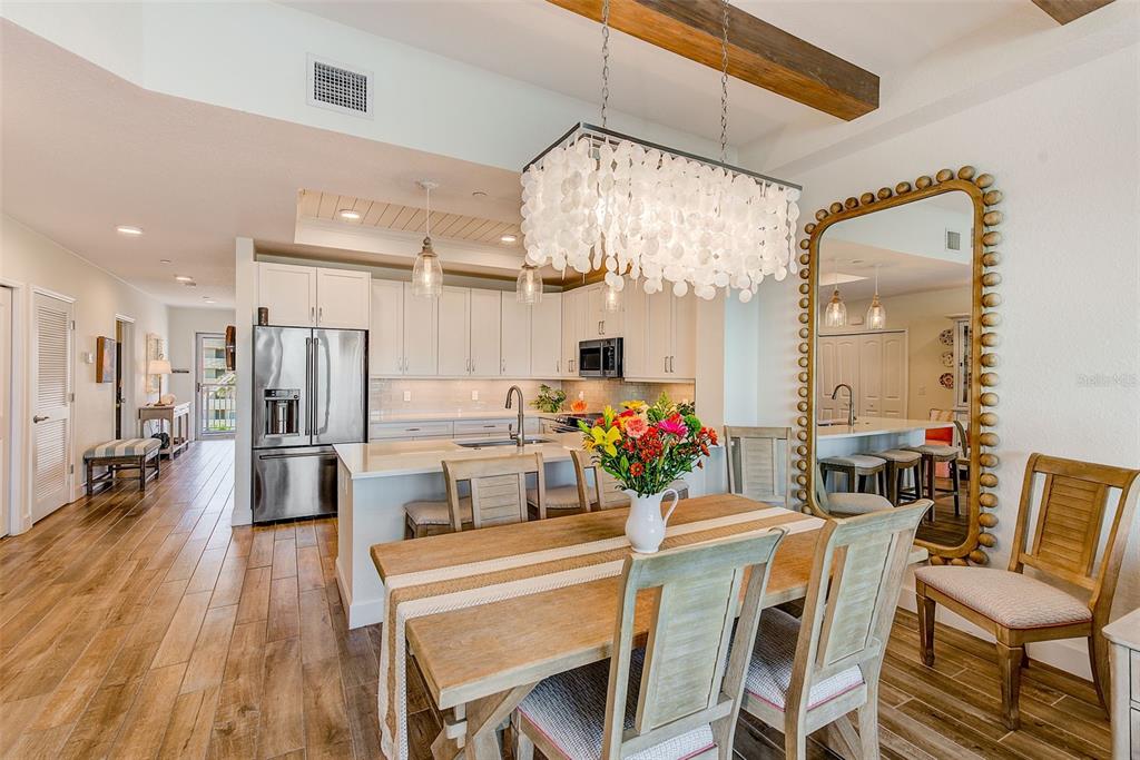 20001 Gulf Boulevard, Unit 403 Indian Shores, FL 33785 - Photo 5 of 43 a view of a dining room and livingroom with furniture wooden floor a chandelier