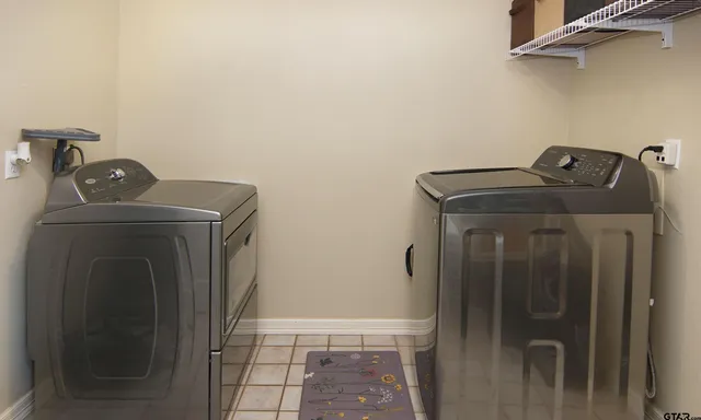a view of storage and utility room with washer and dryer