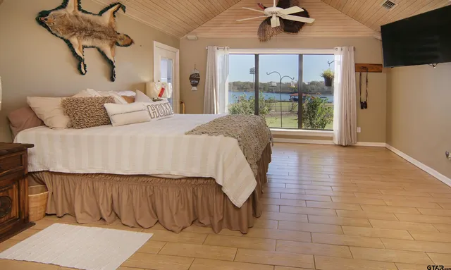 a spacious bedroom with a bed and a chandelier