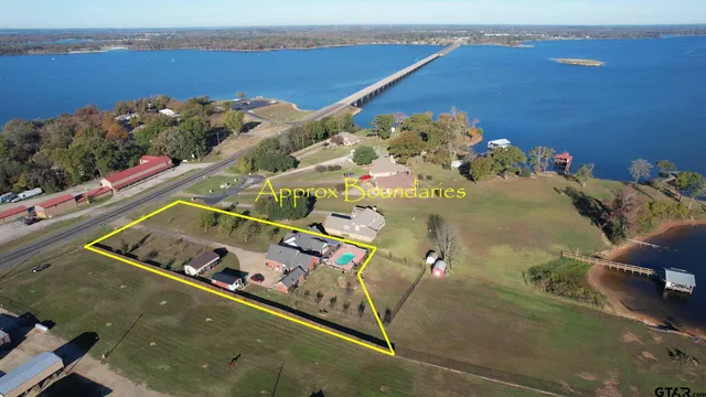 an aerial view of a house a yard swimming pool and outdoor seating