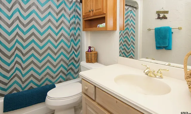 a bedroom with a bed window and cabinet