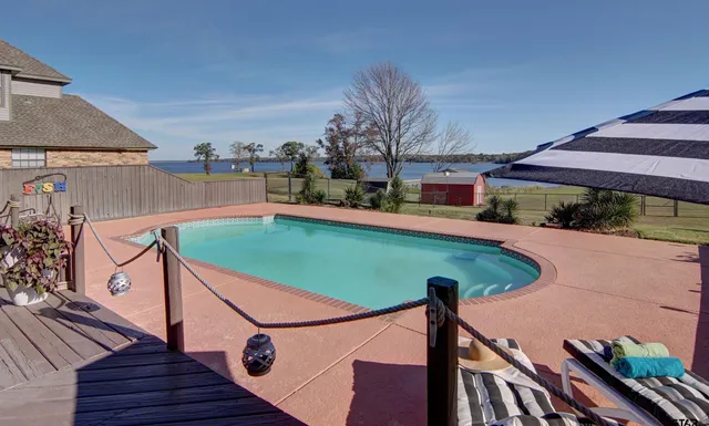 a patio with a table and chairs under an umbrella