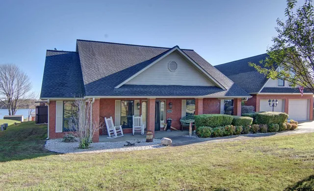 a view of house with yard and glass windows
