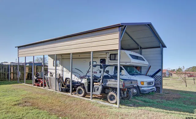 a view of a balcony with chairs and wooden floor