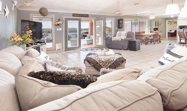 a living room with furniture flowerpot and wooden floor