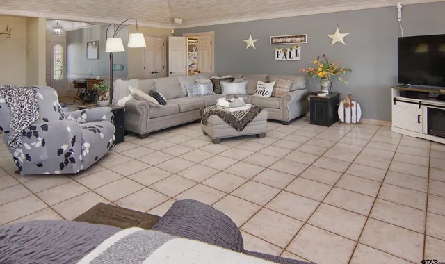a living room with couches and a flat screen tv