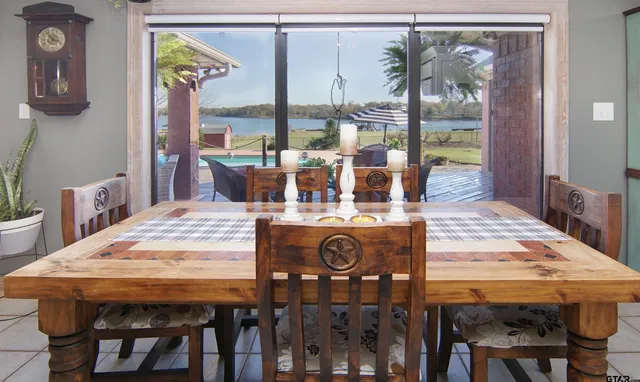 a dining table with chairs and window