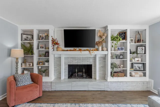 a living room with furniture fireplace and flat screen tv