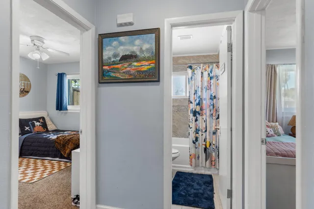 a bedroom with a bed and a painting on the wall