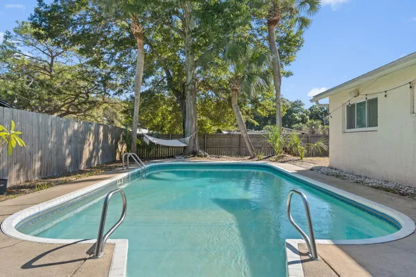 a view of a backyard with swimming pool