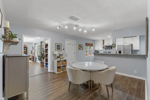 a dining room with furniture and wooden floor