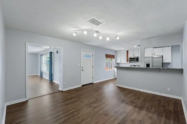 a kitchen with stainless steel appliances granite countertop a stove a sink and a refrigerator