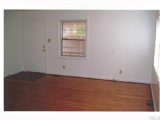 2913 Bardwell Road Raleigh, NC 27604 - Photo 3 of 7 a view of an empty room with wooden floor and a window