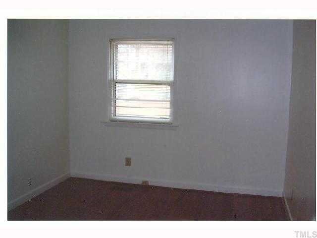 2913 Bardwell Road Raleigh, NC 27604 - Photo 4 of 7 a view of an empty room with wooden floor and a window