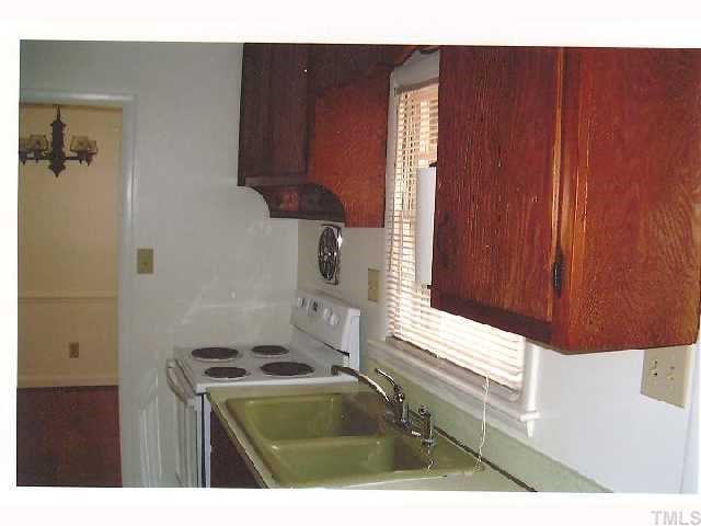 2913 Bardwell Road Raleigh, NC 27604 - Photo 5 of 7 a bathroom with a sink and a mirror