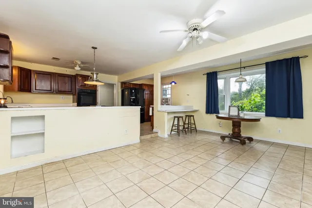 a view of a livingroom with kitchen and furniture
