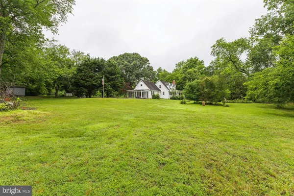 a view of a field with trees in the background