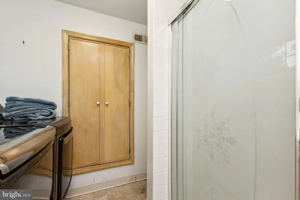 a bathroom with a granite countertop shower and a stove