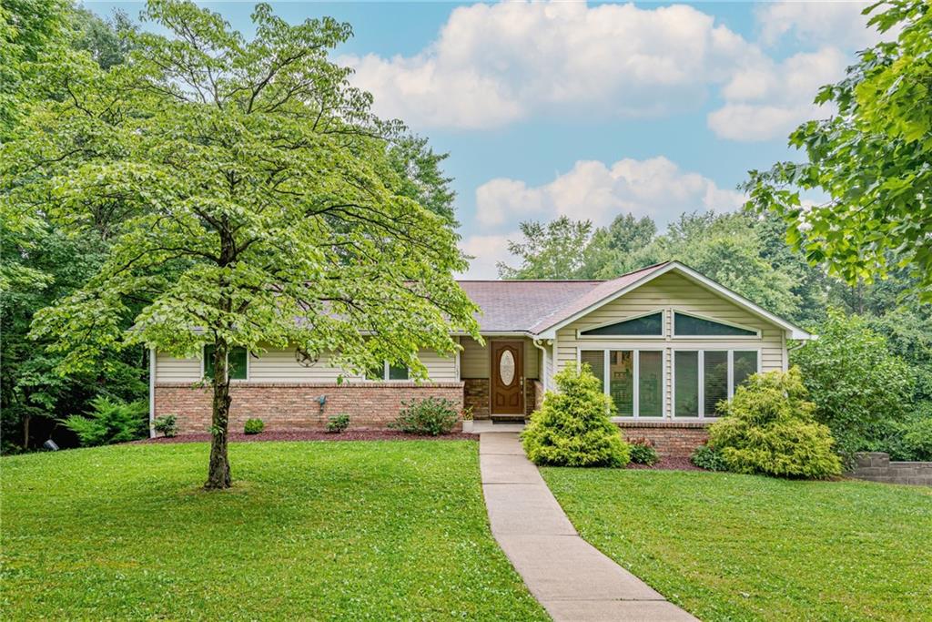 a front view of a house with a yard