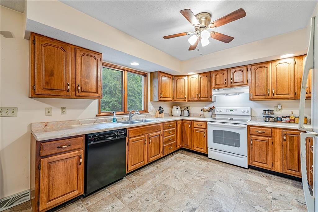 257 Fallen Timber Road Avella, PA 15312 - Photo 9 of 32 a kitchen with granite countertop a stove sink cabinets and window