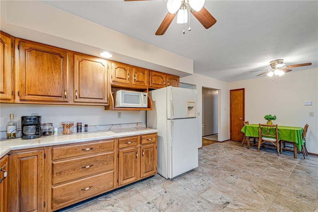 257 Fallen Timber Road Avella, PA 15312 - Photo 10 of 32 a kitchen with a refrigerator a microwave a dining table and chairs