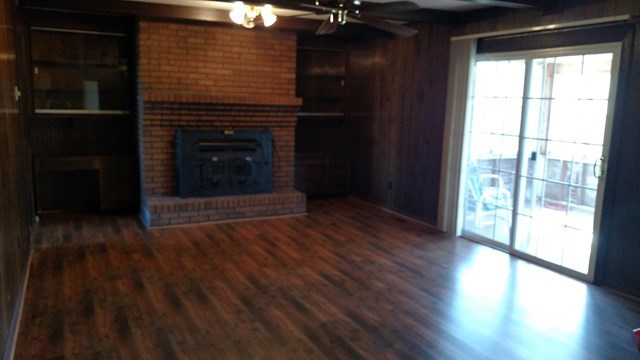 1841 Bonner Gilbert Road Macon, GA 31220 - Photo 6 of 20 a view of a hallway with wooden floor and a fireplace