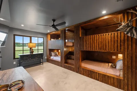 a bedroom with furniture and a flat screen tv