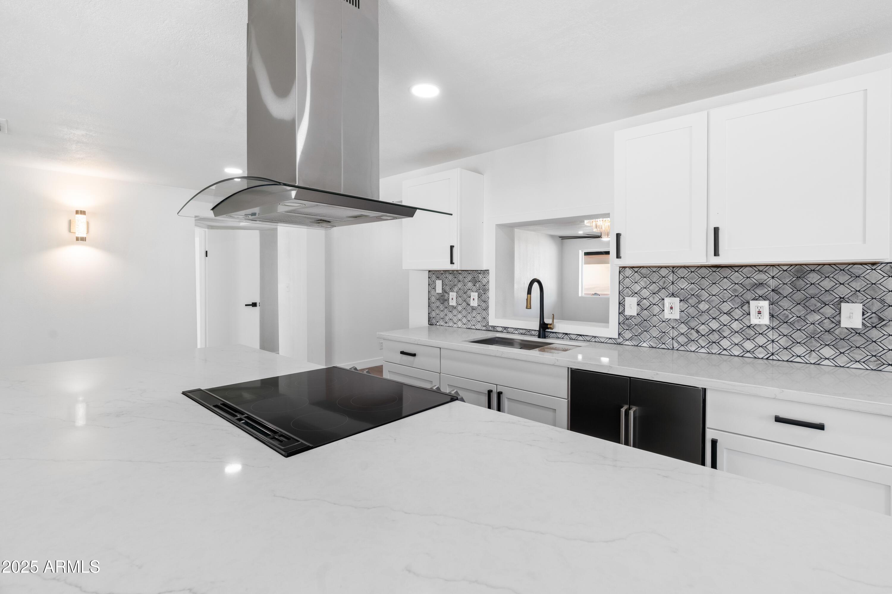 901 West Mercer Lane Phoenix, AZ 85029 - Photo 11 of 40 a kitchen with stainless steel appliances a sink a stove a refrigerator white cabinets and wooden floor