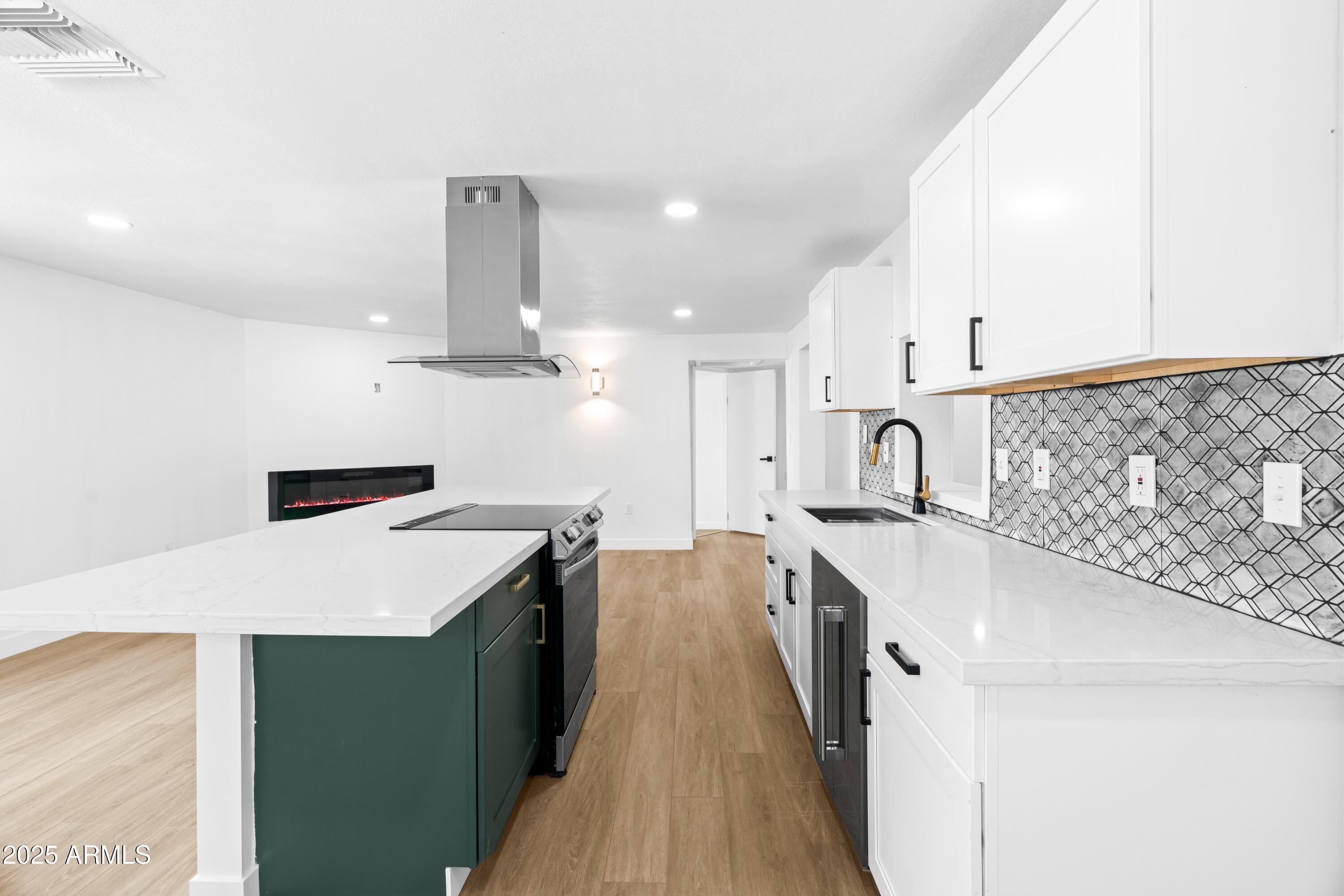901 West Mercer Lane Phoenix, AZ 85029 - Photo 12 of 40 a kitchen with a sink a stove and cabinets