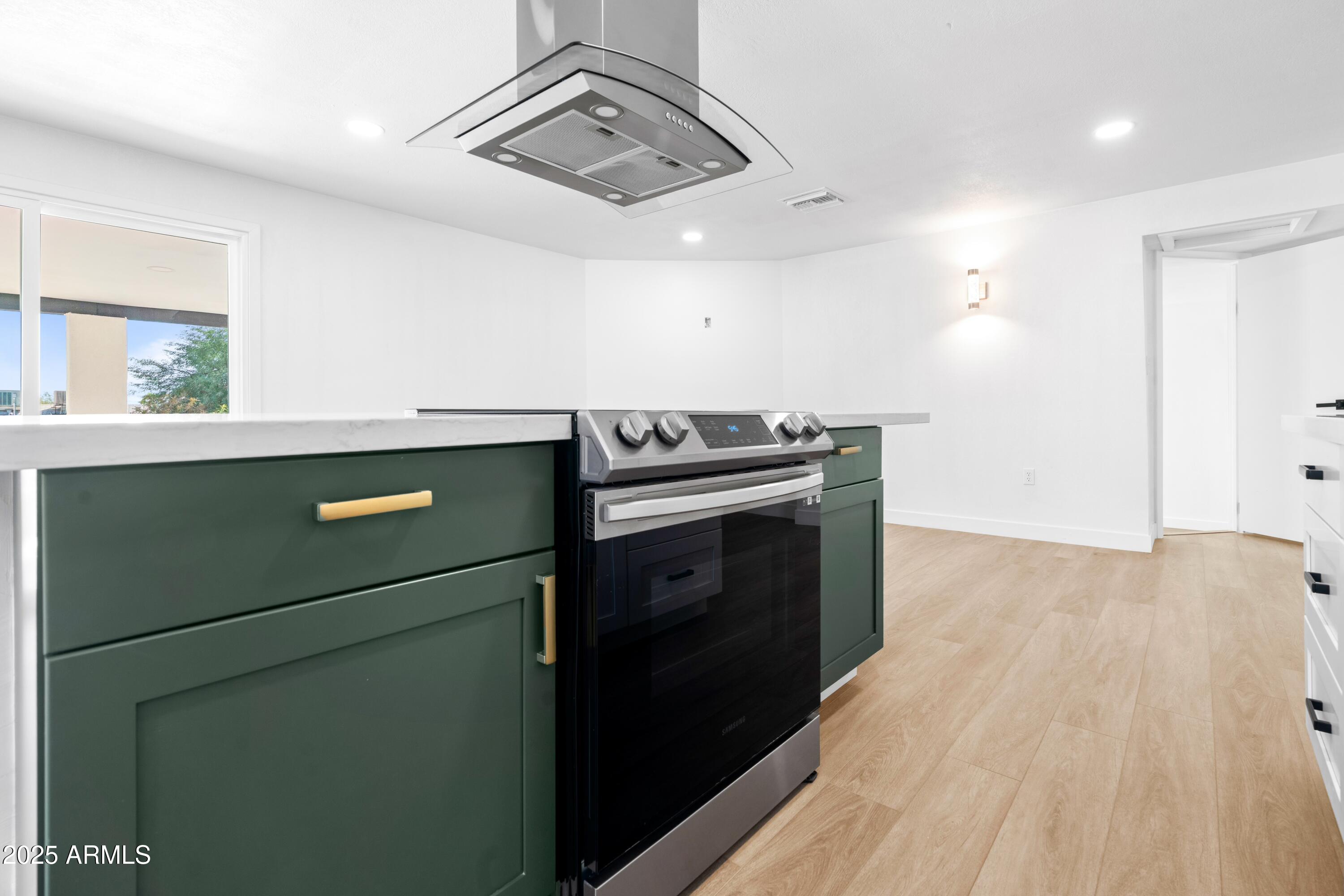 901 West Mercer Lane Phoenix, AZ 85029 - Photo 13 of 40 a kitchen with a stove and a refrigerator
