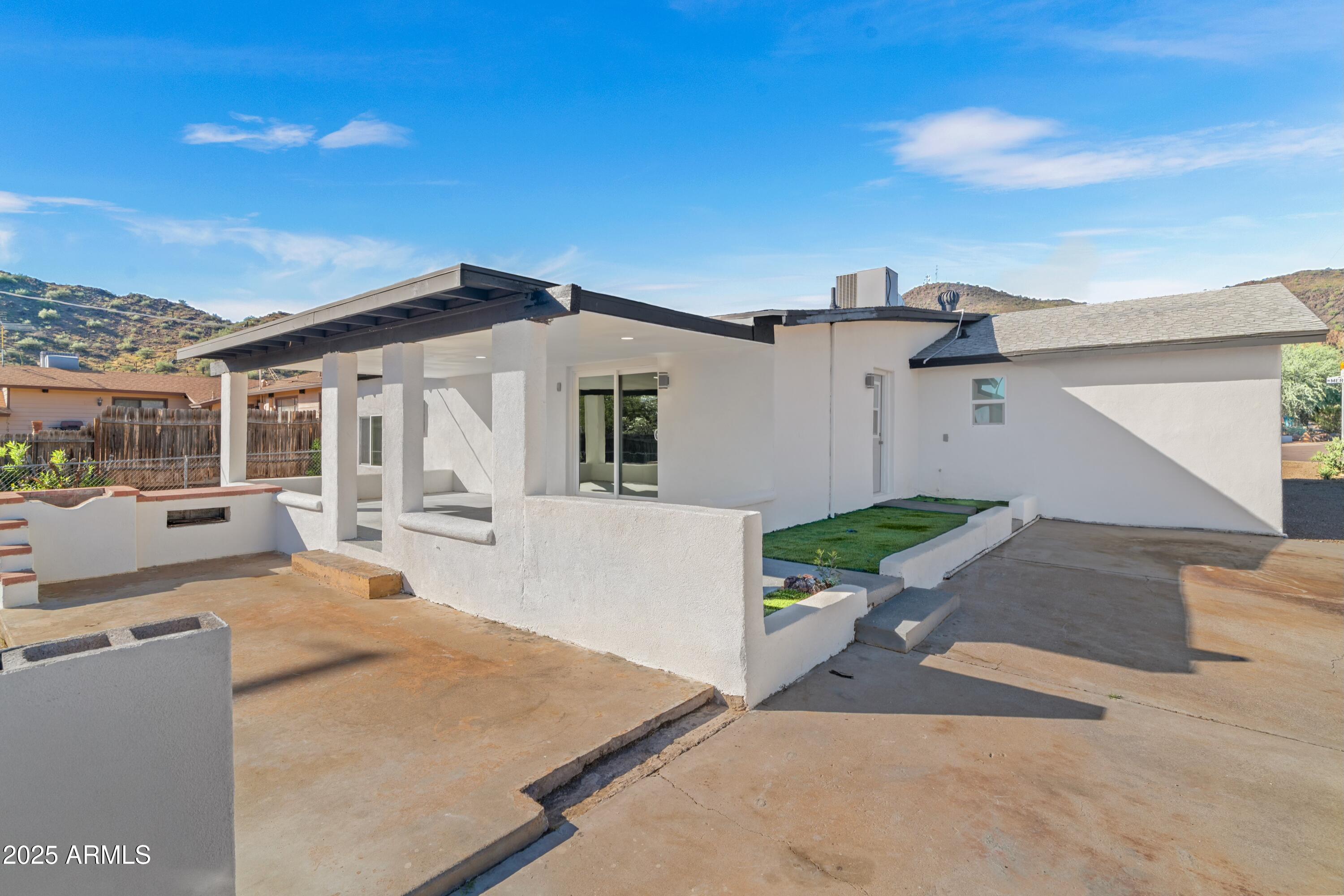 901 West Mercer Lane Phoenix, AZ 85029 - Photo 2 of 40 a front view of a house with a yard and garage