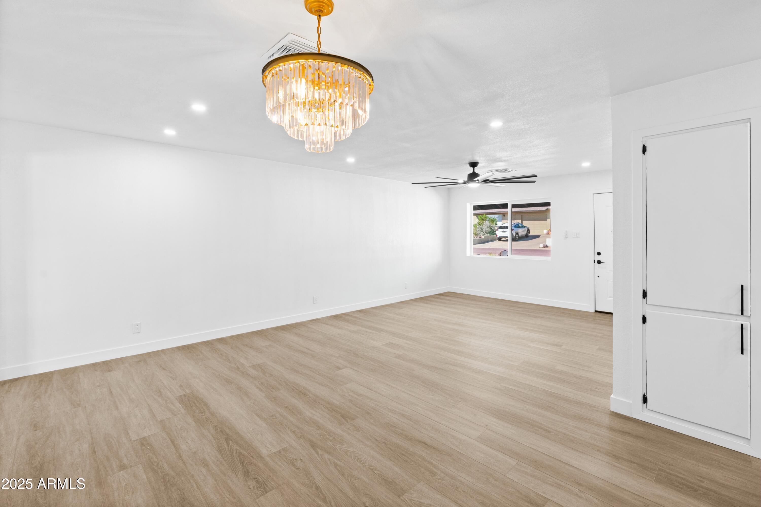 901 West Mercer Lane Phoenix, AZ 85029 - Photo 23 of 40 an empty room with wooden floor and windows