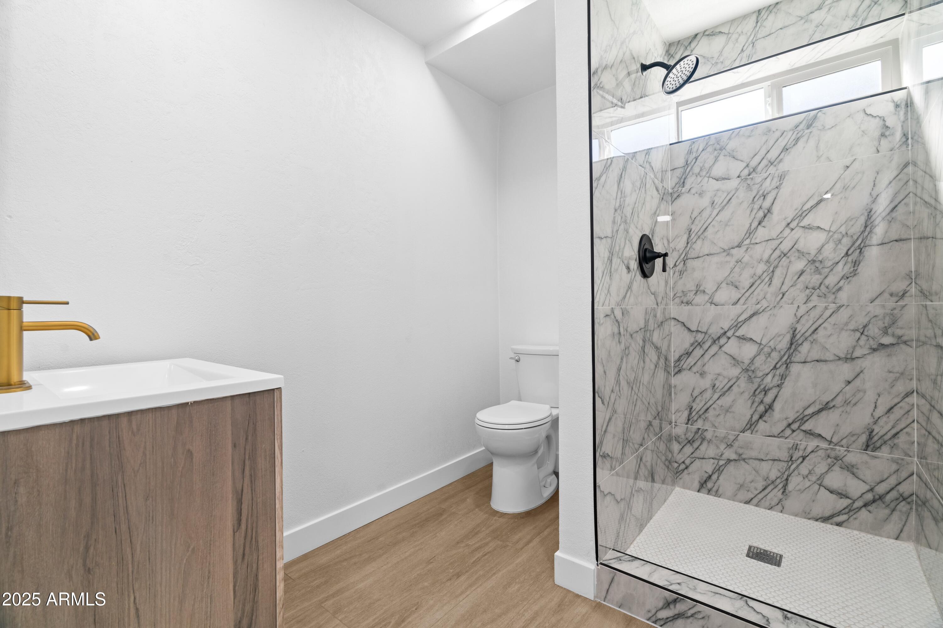 901 West Mercer Lane Phoenix, AZ 85029 - Photo 27 of 40 a bathroom with a granite countertop white toilet and a shower
