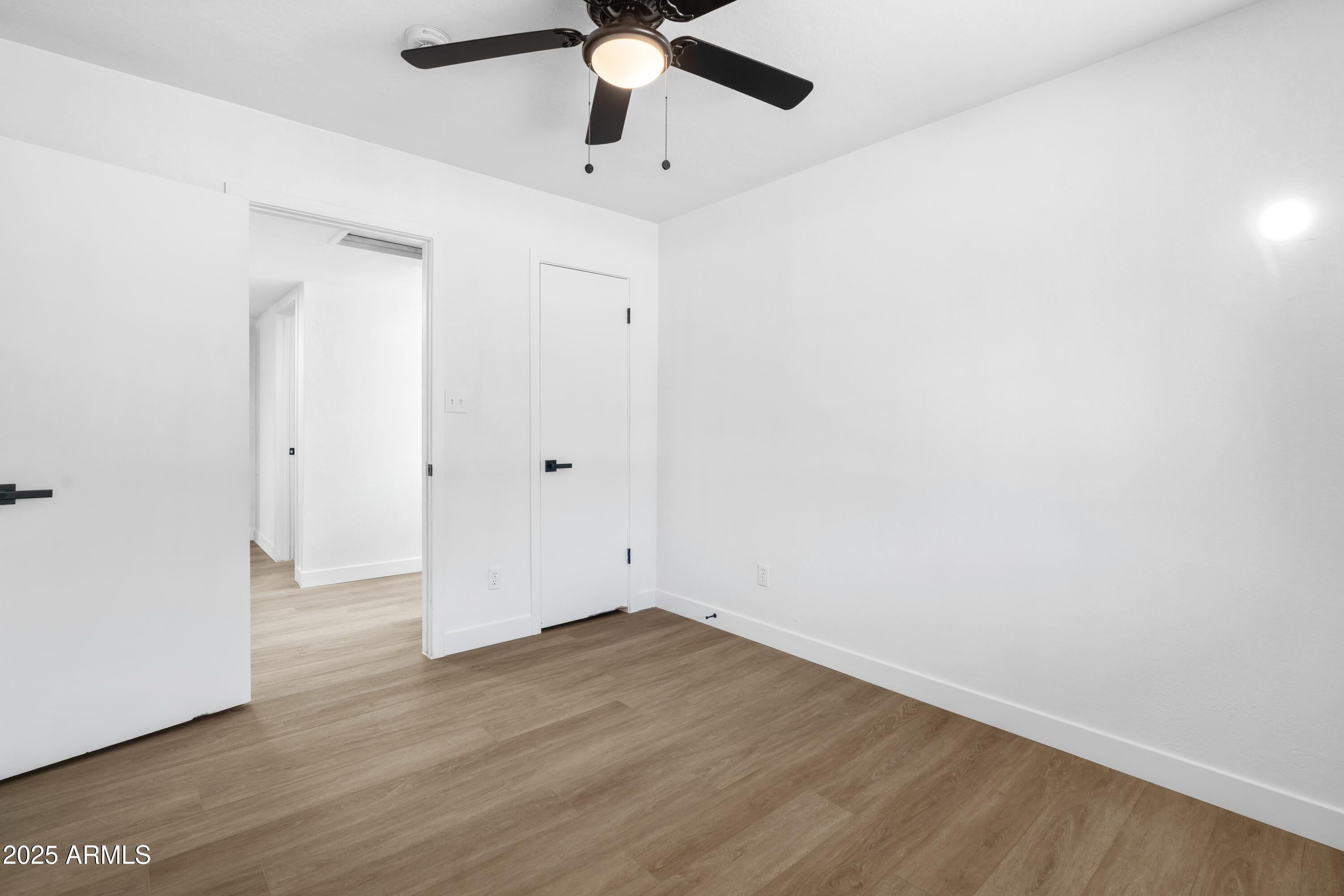 901 West Mercer Lane Phoenix, AZ 85029 - Photo 30 of 40 an empty room with a window and a ceiling fan