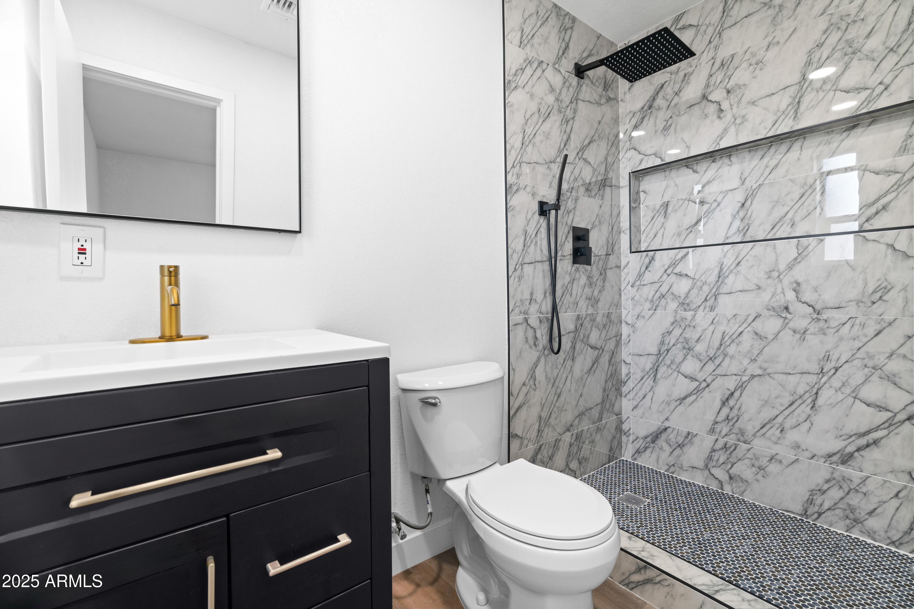 901 West Mercer Lane Phoenix, AZ 85029 - Photo 33 of 40 a bathroom with a sink a toilet a mirror and shower curtain