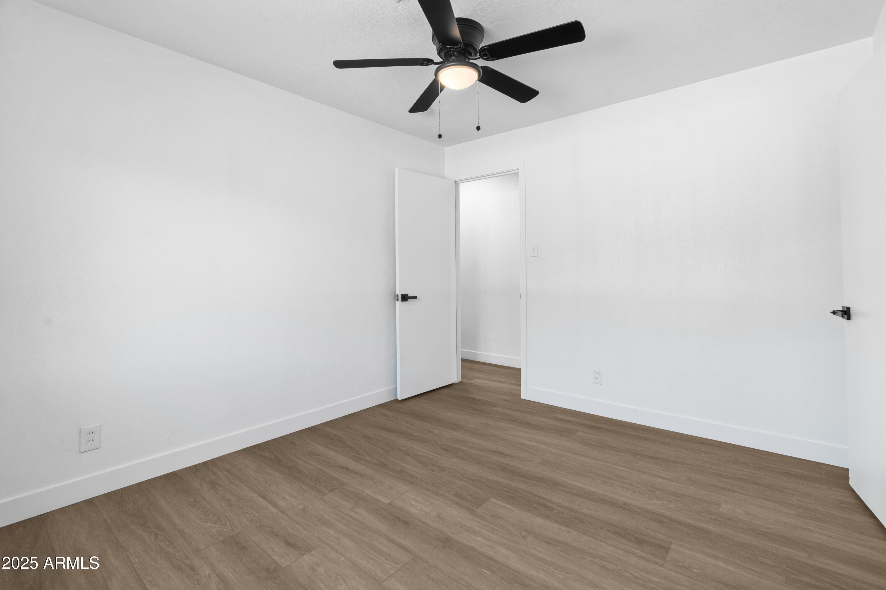 901 West Mercer Lane Phoenix, AZ 85029 - Photo 35 of 40 a view of an empty room with wooden floor