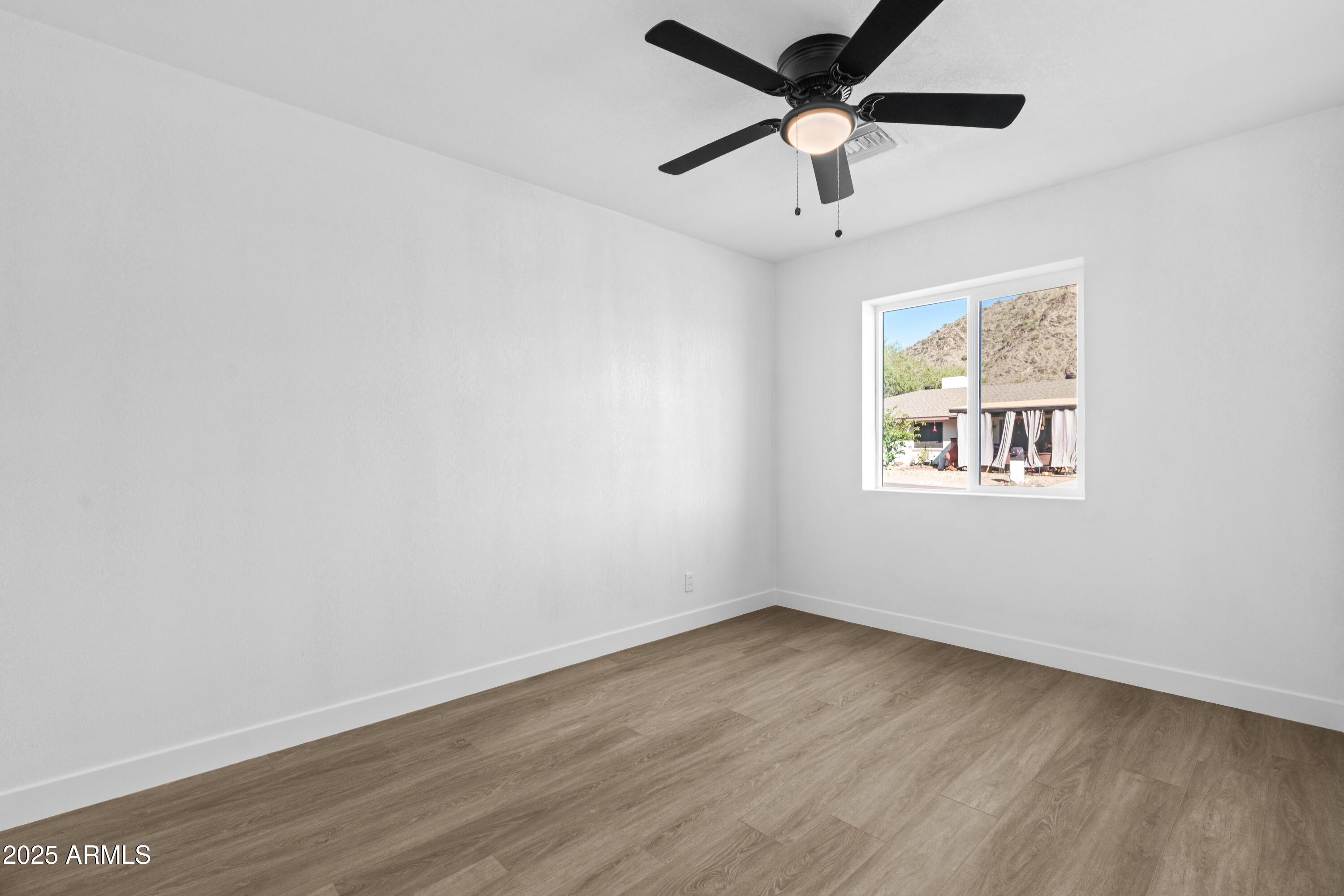 901 West Mercer Lane Phoenix, AZ 85029 - Photo 37 of 40 wooden floor in an empty room with a window