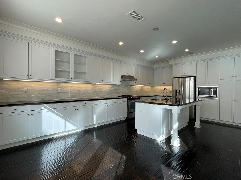 108 Pendant Irvine, CA 92620 - Photo 13 of 36 a kitchen with stainless steel appliances granite countertop a sink a stove and a refrigerator