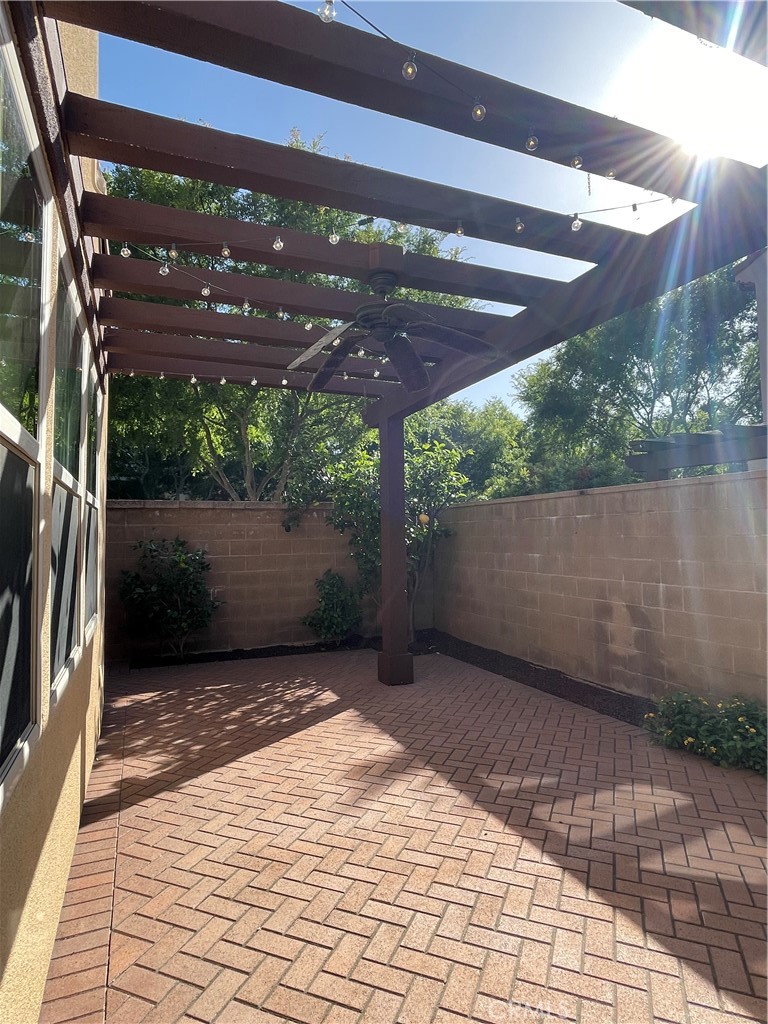 108 Pendant Irvine, CA 92620 - Photo 15 of 36 a view of a patio with a table and chairs under an umbrella