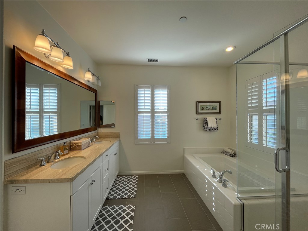 108 Pendant Irvine, CA 92620 - Photo 22 of 36 a bathroom with a tub sink and mirror